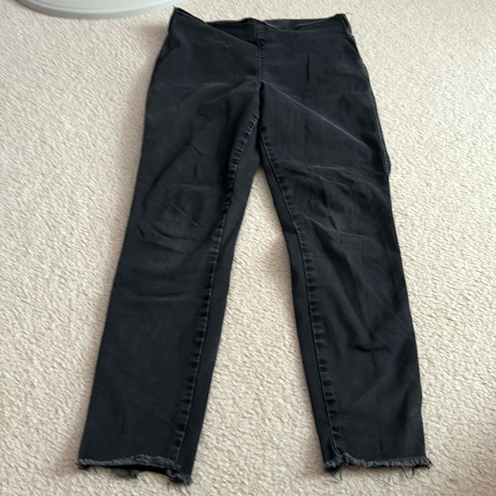 Black frayed jeggings with pockets.